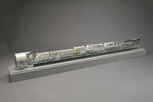 Detailiertes Modell eines großen Wasserstoff-Brennstoffzellensystems mit sichtbaren Komponenten, darunter ein Kraftstofftank, ein Filter und ein Injektor, die mit einer Stromquelle auf einer weißen Oberfläche verbunden sind.