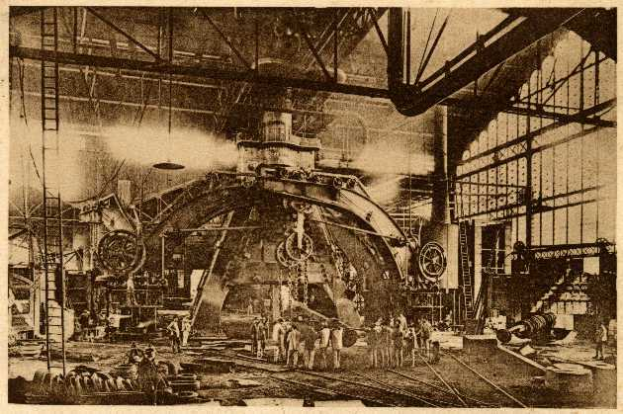 Ein Schwarz-Weiß-Foto einer Fabrikszene in der Cadillac Steel Works, das Arbeiter bei der Bedienung einer großen Maschine zeigt, umgeben von Leitern und Stangen.