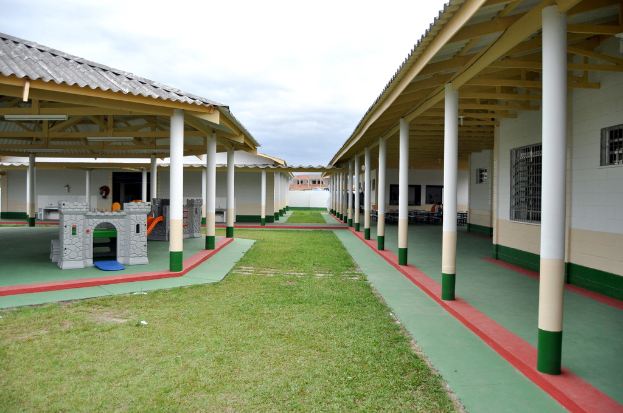 Notunterkünfte mit Säulen und Räumen, umgeben von einer Grasfläche.